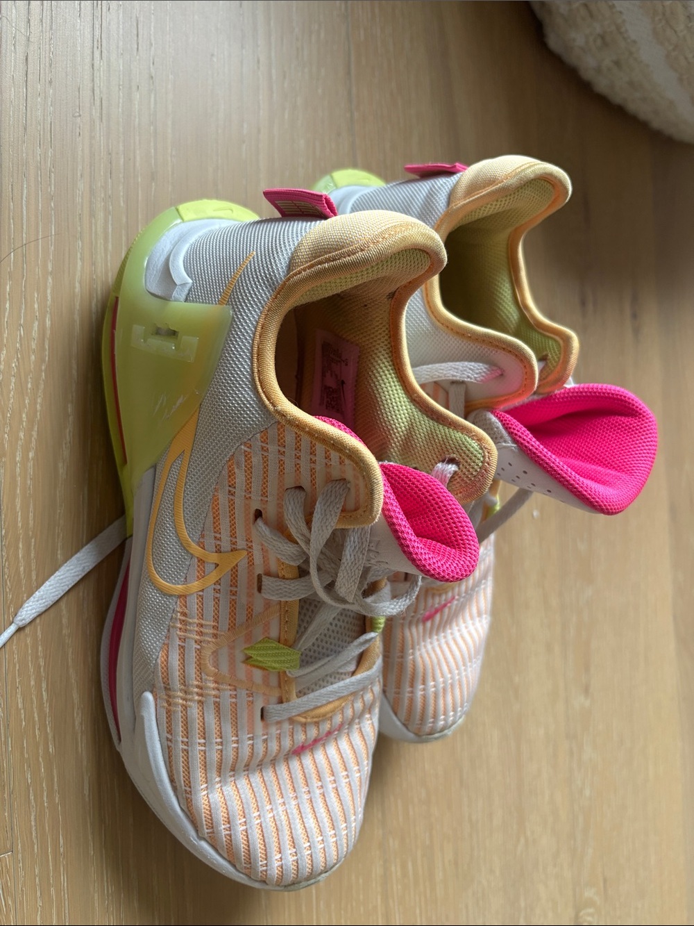 Nike women’s Orange Striped Sneakers with Neon Pink Accents